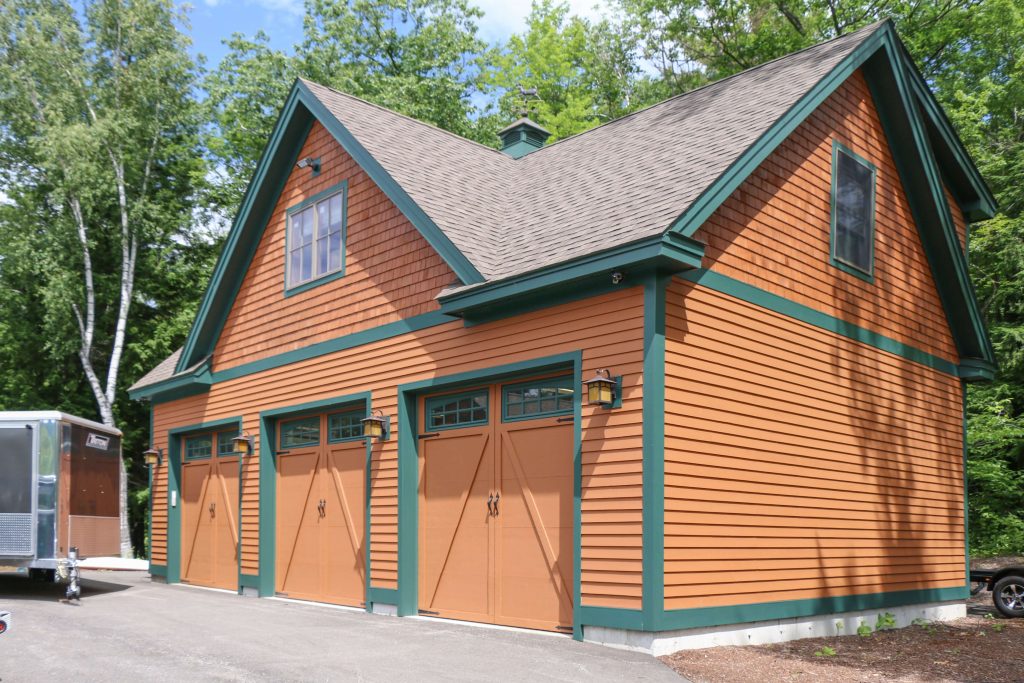 front of home with three barn style garage doors